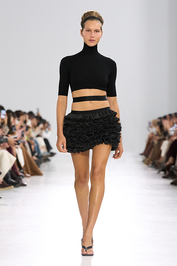 Max Mara Spring/Summer 2026 Fashion Show - Look with Turtleneck and matching black Miniskirt.